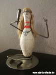 Recycling art bowling pins figure Footballer.