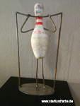 Recycling art bowling pins figure gymnastics.