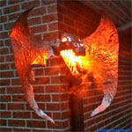 Order work. Outdoor dragon lamp for a house wall.
