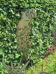 Garden-stakes metal sheet parrot upon rod.