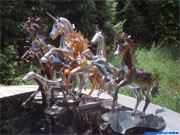Photo installation of unicorns and horses in the garden.
